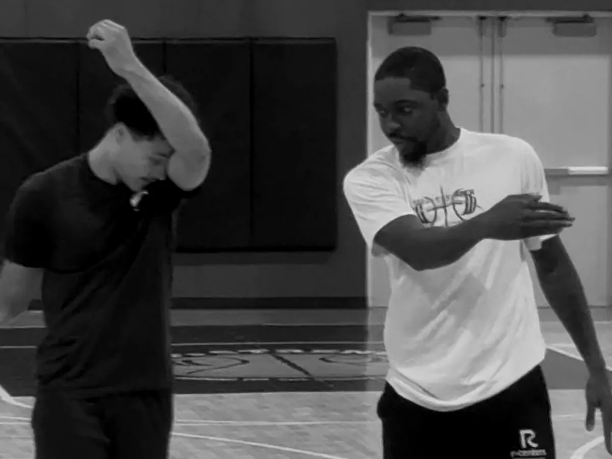 Trainer working one-on-one with a player on ball handling